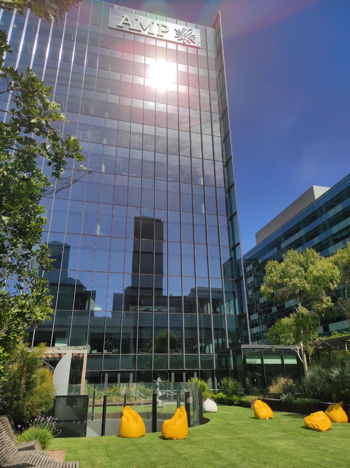 Sun reflected in the mirror glass of a high rise building