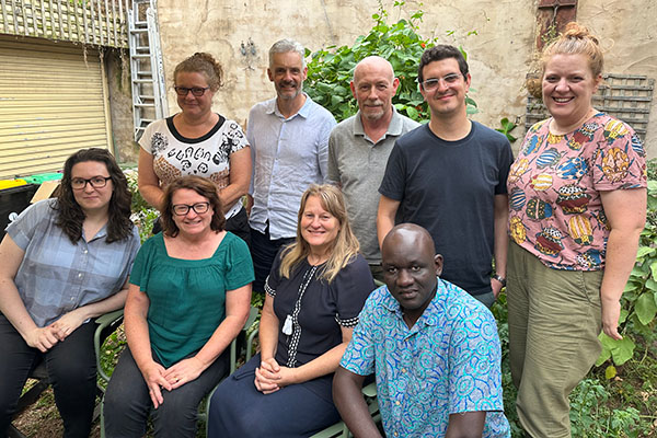 Members of the Rural Innovation Research Group posing together in a garden courtyard
