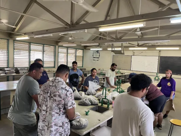 People working with soil samples in a classroom.