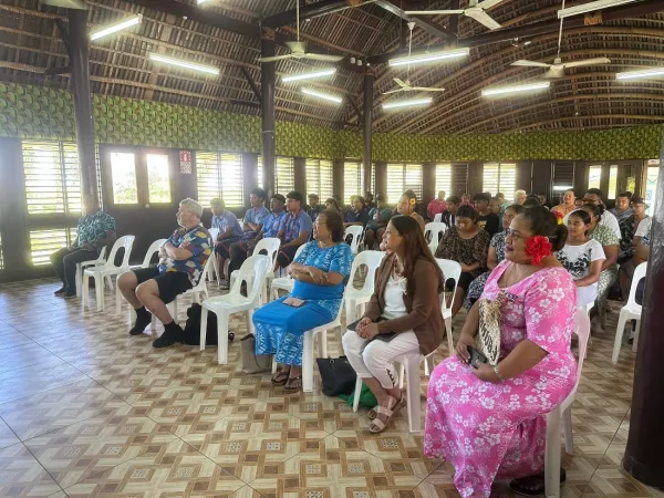 Group sitting in gathering hall.