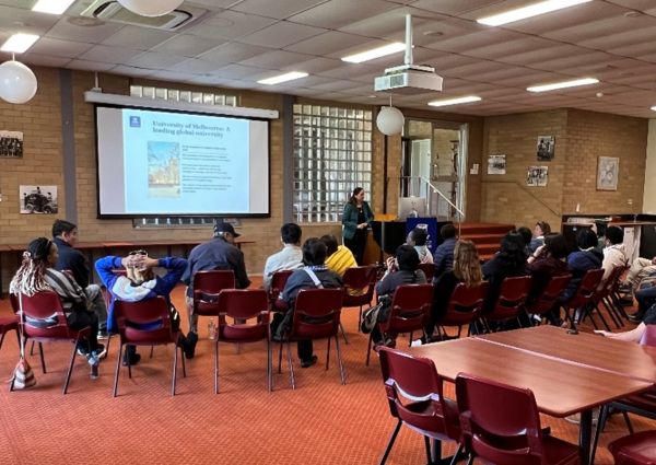 A/Prof Dorin Gupta presenting to a room full of people from a lectern.