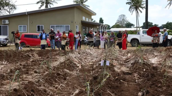 People gathered next to a field.