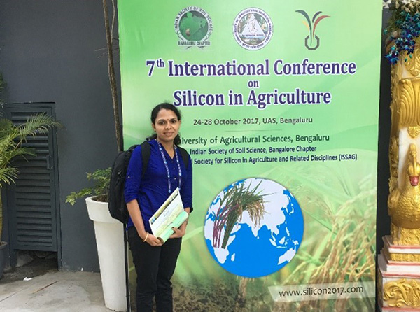 Dr Sajitha Biju posing in front of conference banner