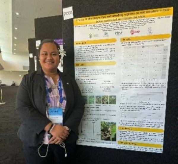 Woman standing in front of her poster.