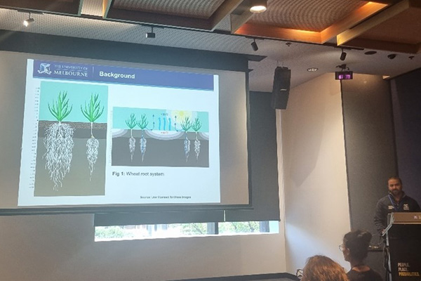 Dr Waseem Ashfaq at lectern presenting to a roomful of people at SECAN conference 2023