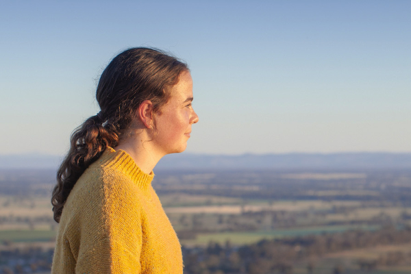 Young woman looking out to horizon.