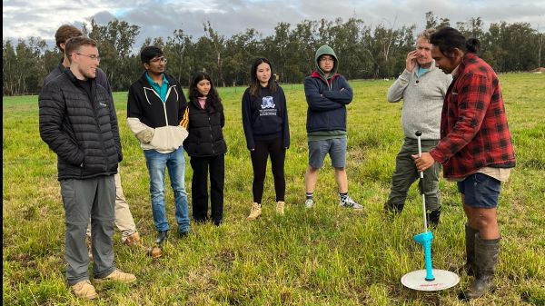Students in paddock with rising plate meter