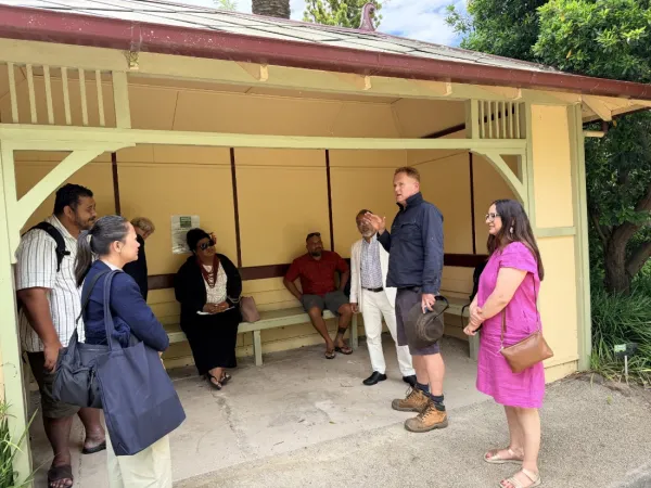 People waiting at a bus shelter.